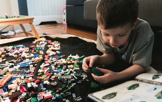 A boy playing with LEGOs