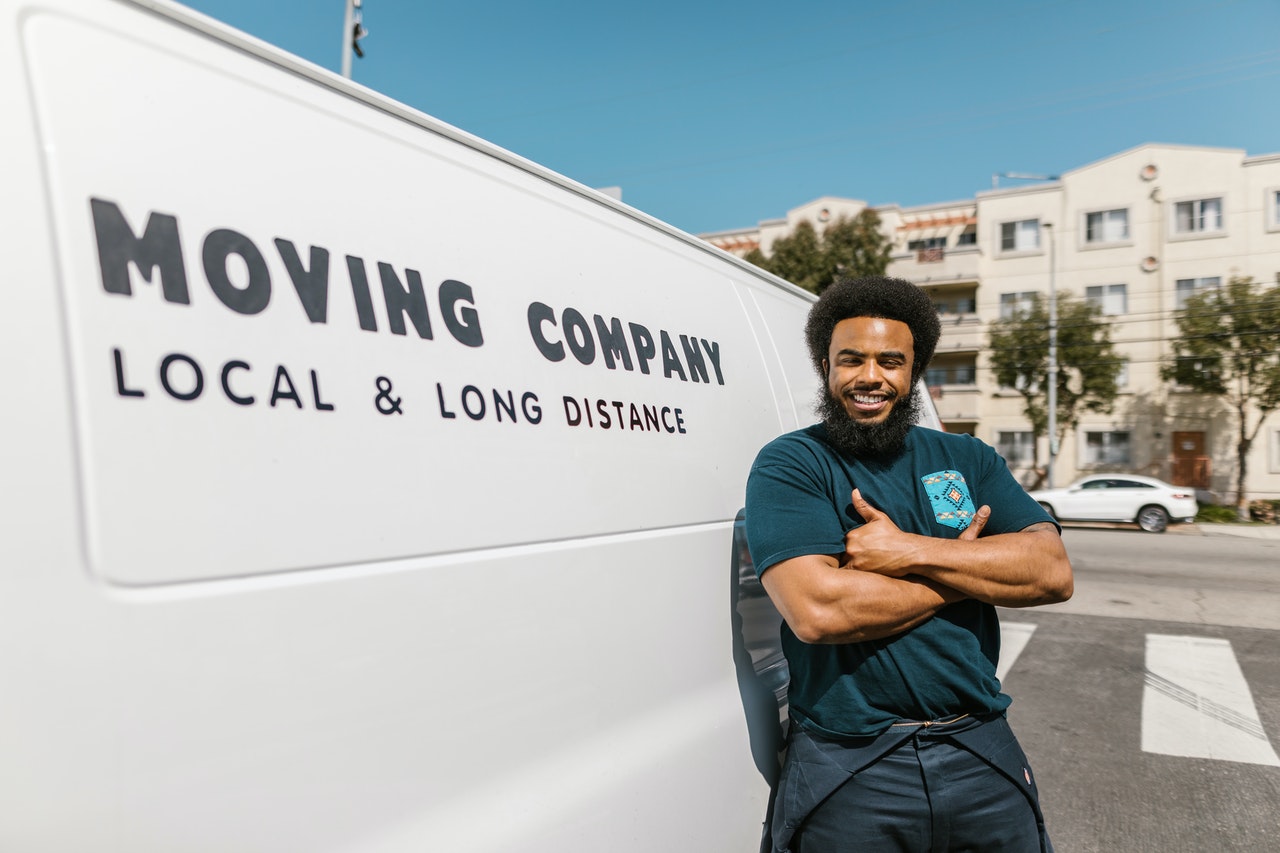 A member of a moving crew next to a moving truck