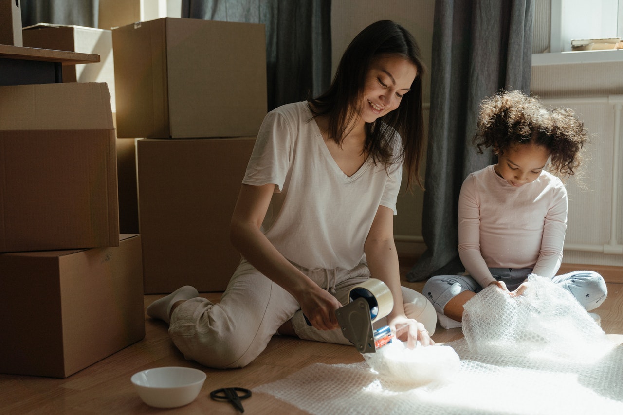 A mother and daughter packing for a move
