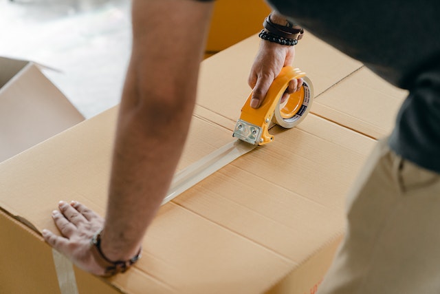 A man sealing a box