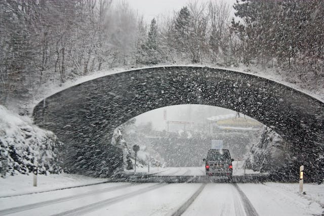 A car moving during a blizzard.

